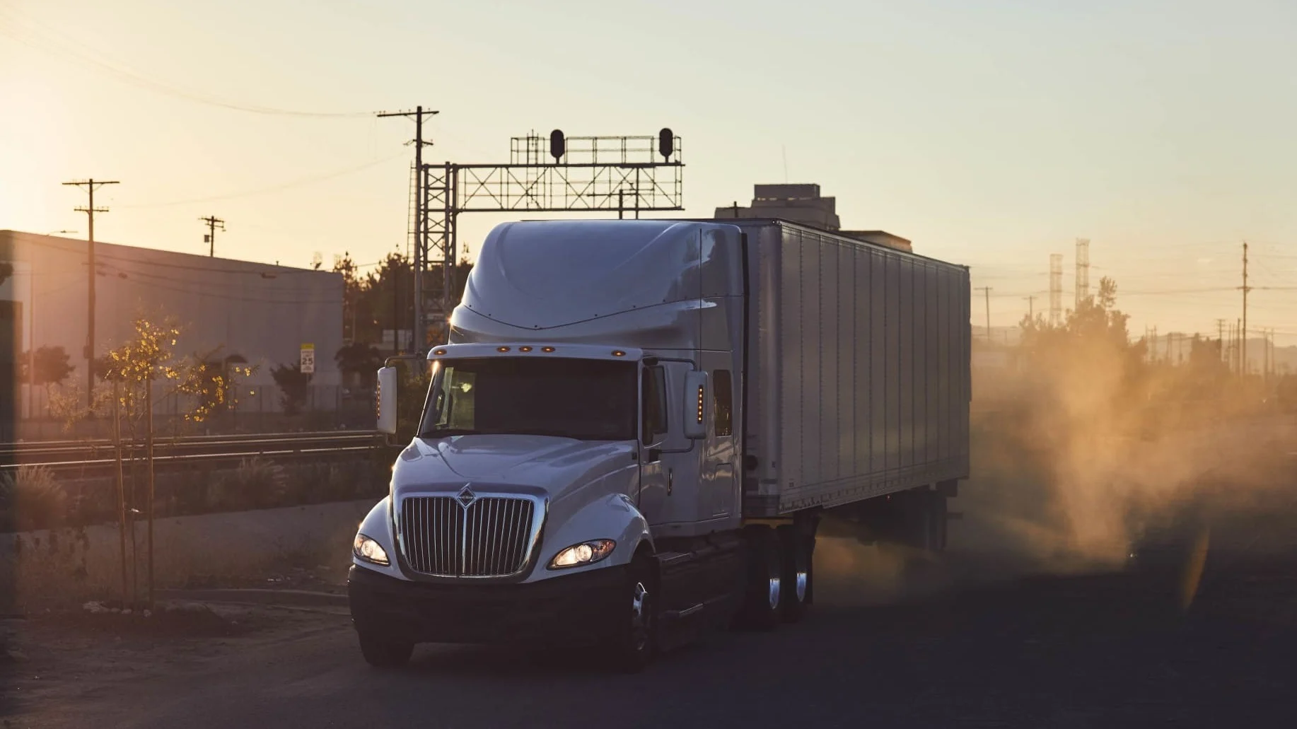 Truck driving with dust cloud following